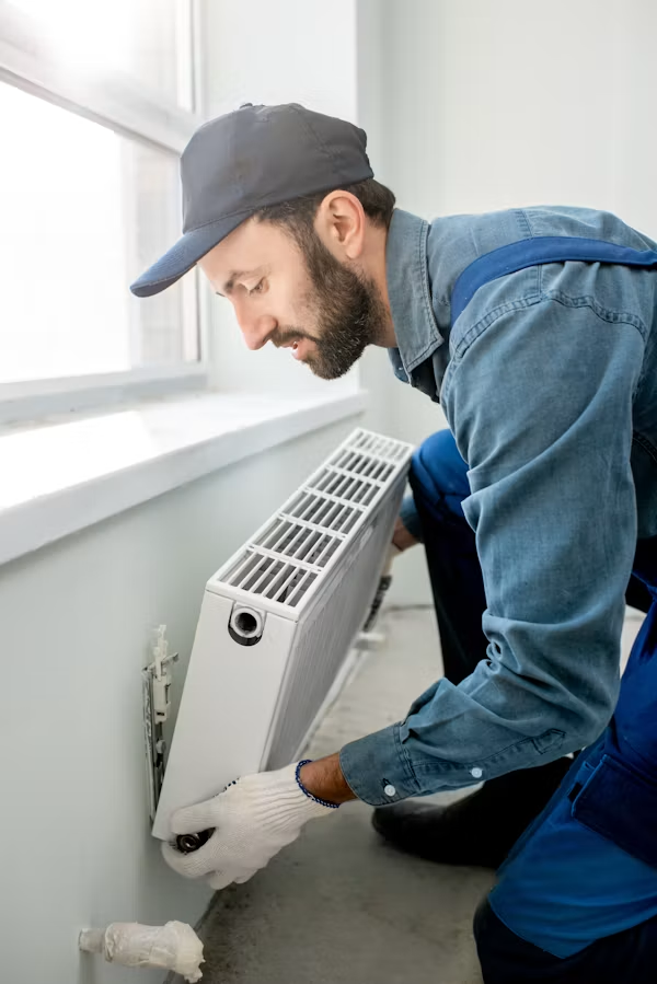 HVAC technician servicing home heating equipment to support indoor air quality in California