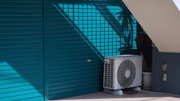 Outdoor air conditioning condenser installed beside a residential property after HVAC repair services in California