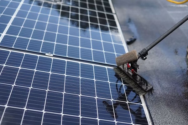 Professional solar panel cleaning company California crew using soft-bristle tools