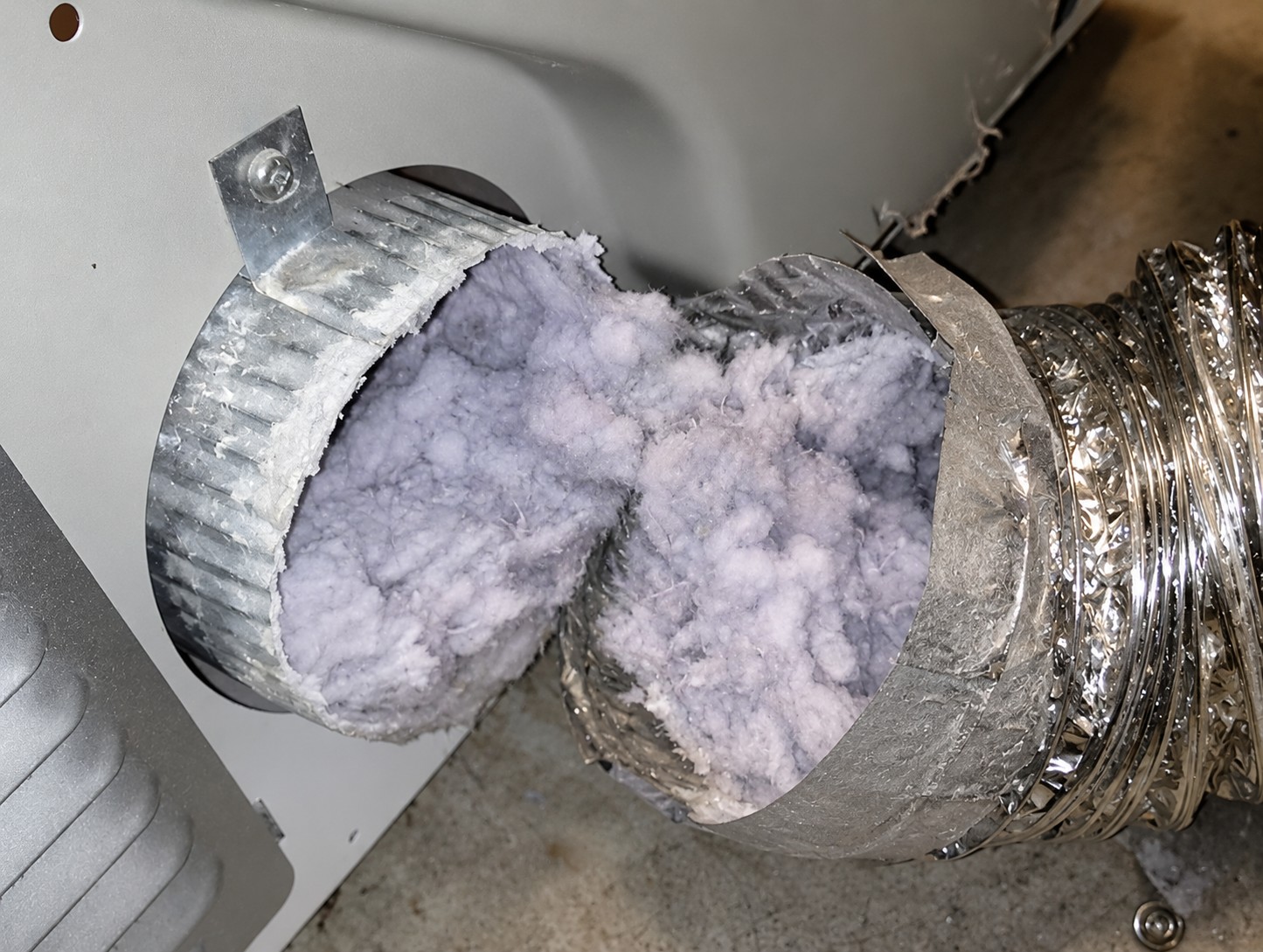 Severely clogged dryer vent filled with lint, highlighting the need for professional dryer vent cleaning in California.