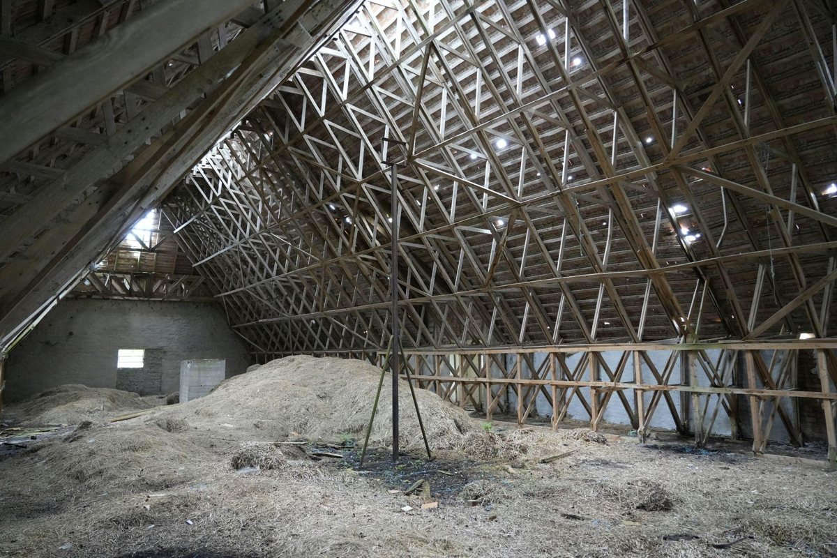 An unfinished attic with exposed roof trusses illustrates the importance of effective attic insulation in Turlock.