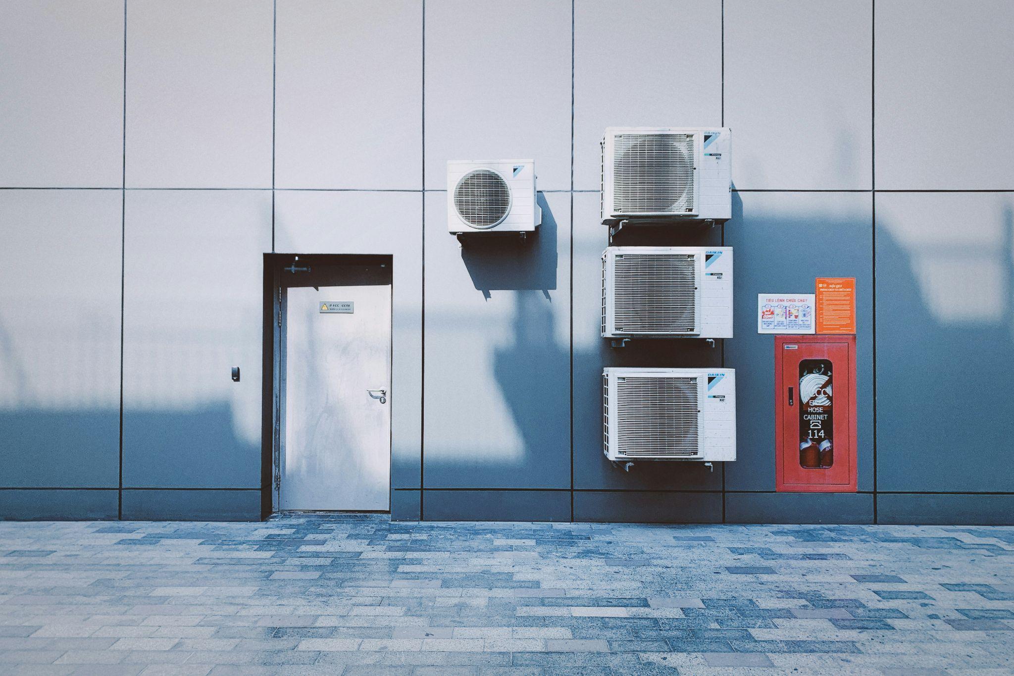 Multiple exterior AC units representing HVAC services in California.